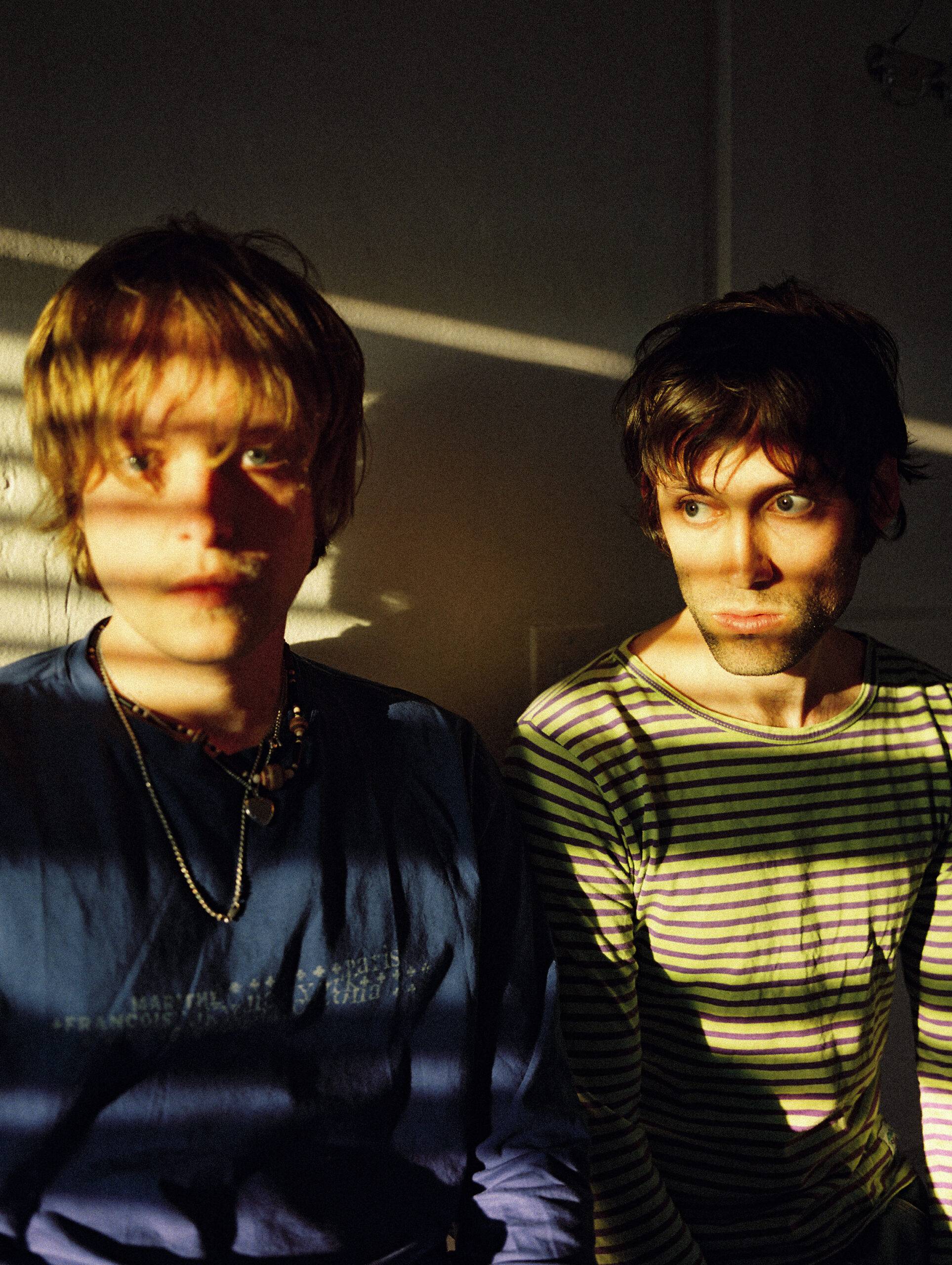 Picture of Kids Return band, with sunlight shining through binds on their faces