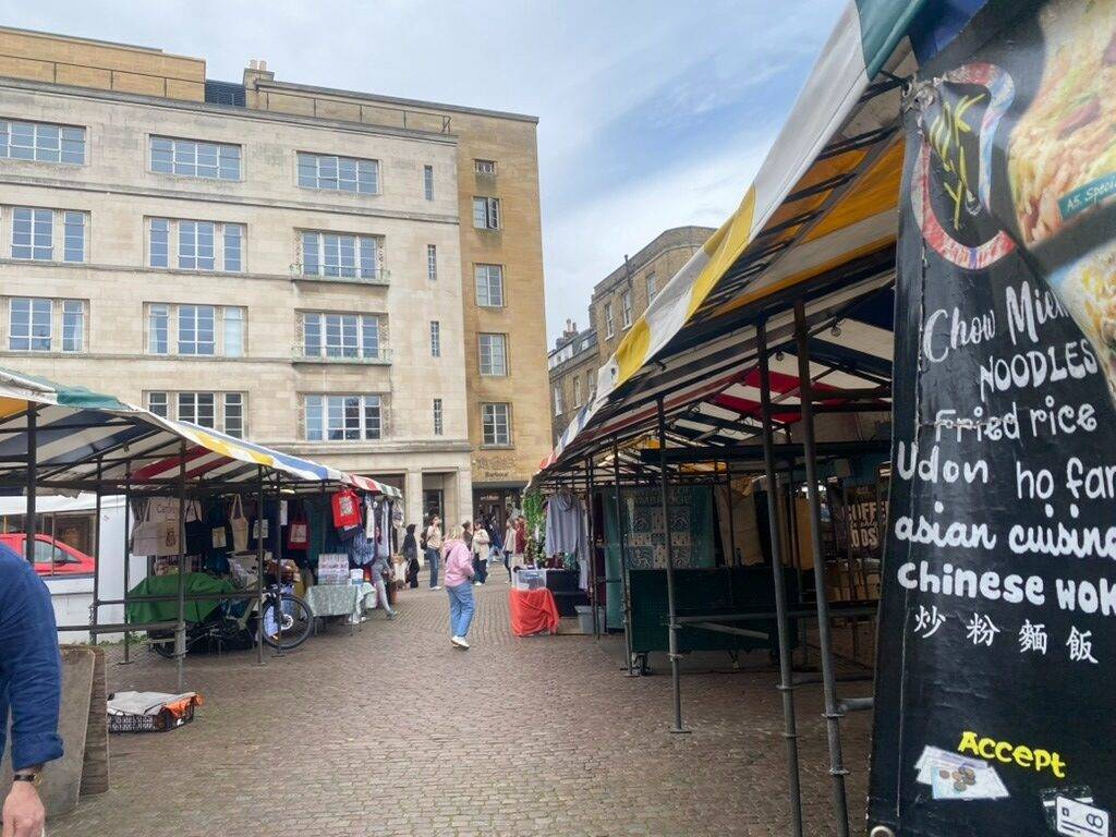 A picture of a street market with stalls in Cambridge