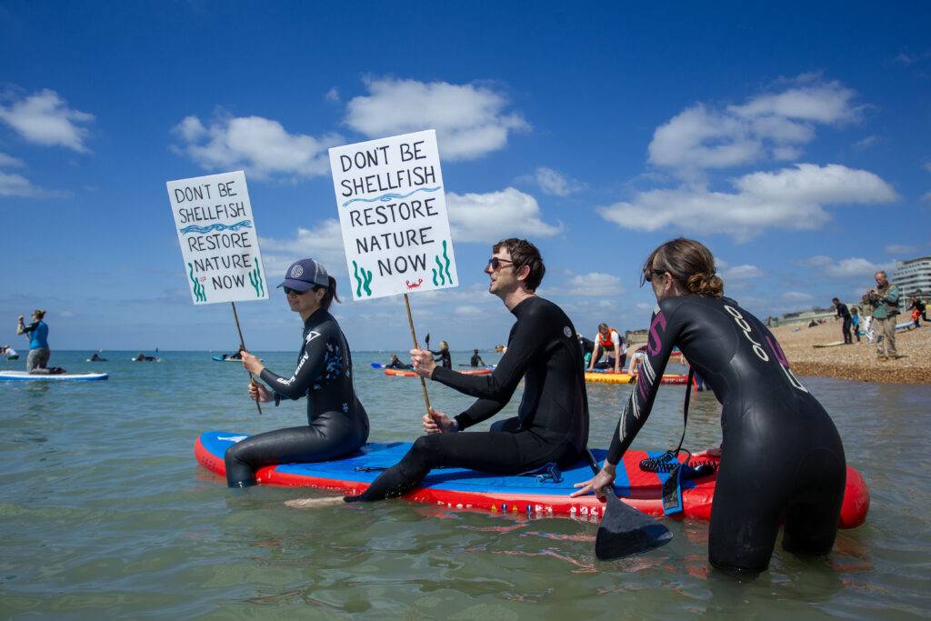 Brighton paddle out protest against sewage pollution at the West Pier